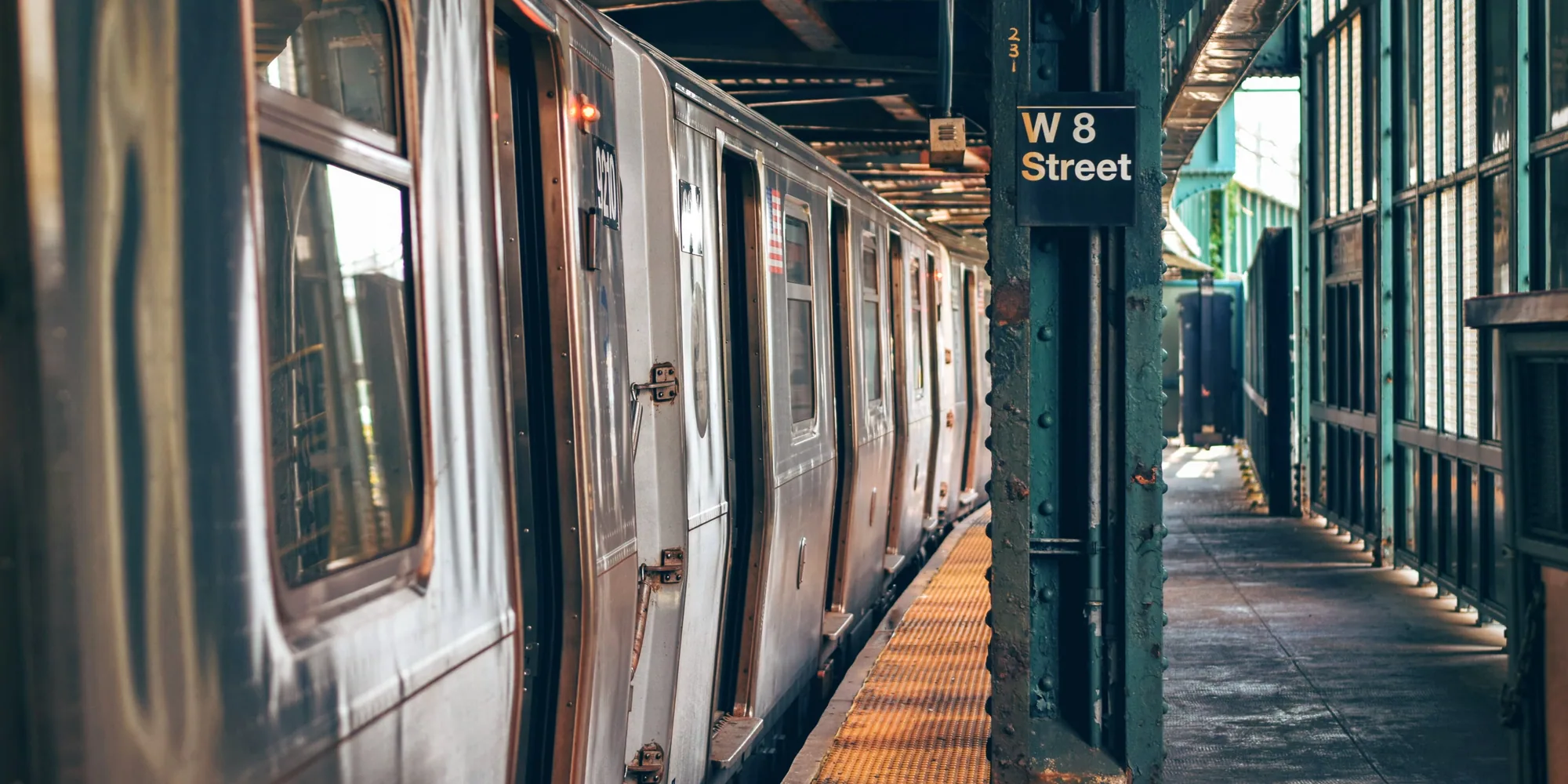 A New York City subway train stopped at the West 8th Street platform